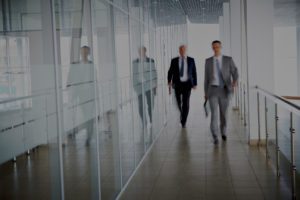Property managers that use Easy Work Order's work order management system, walking in the office corridor