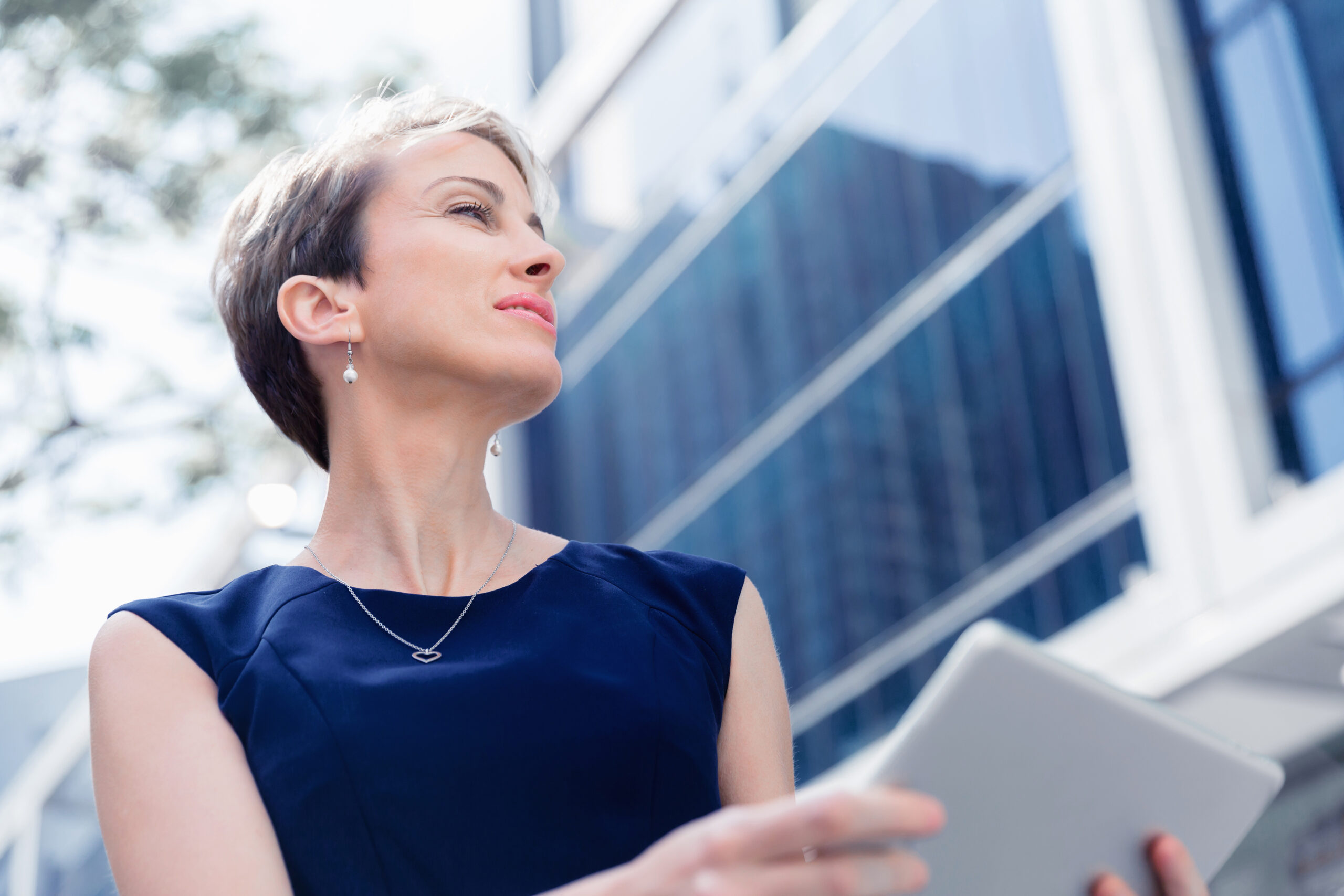 Businesswoman in city holding his notebook