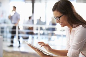 happy woman using easy work order's enterprise saas software to check on her portfolio
