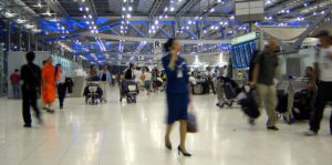 Busy airport facilities manager walking through airport discussing easy work order's enterprise saas software to the ceo of the airport